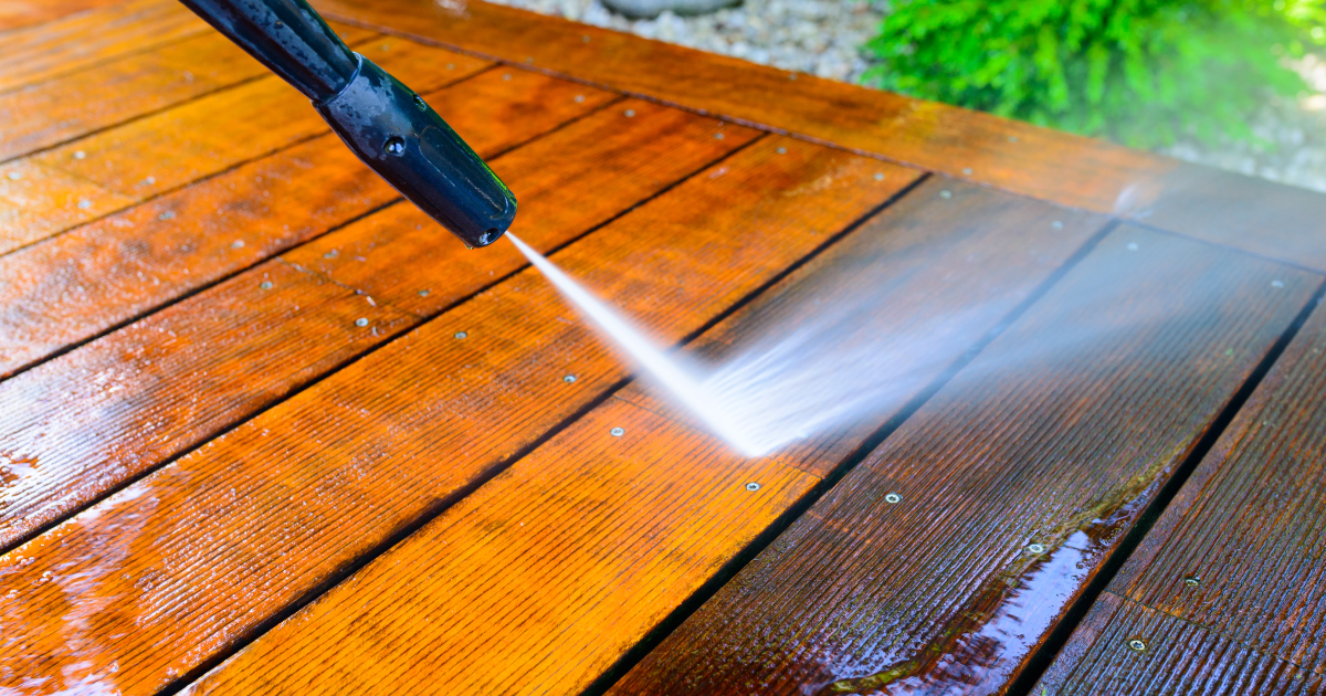 Pressure washer cleaning wood deck
